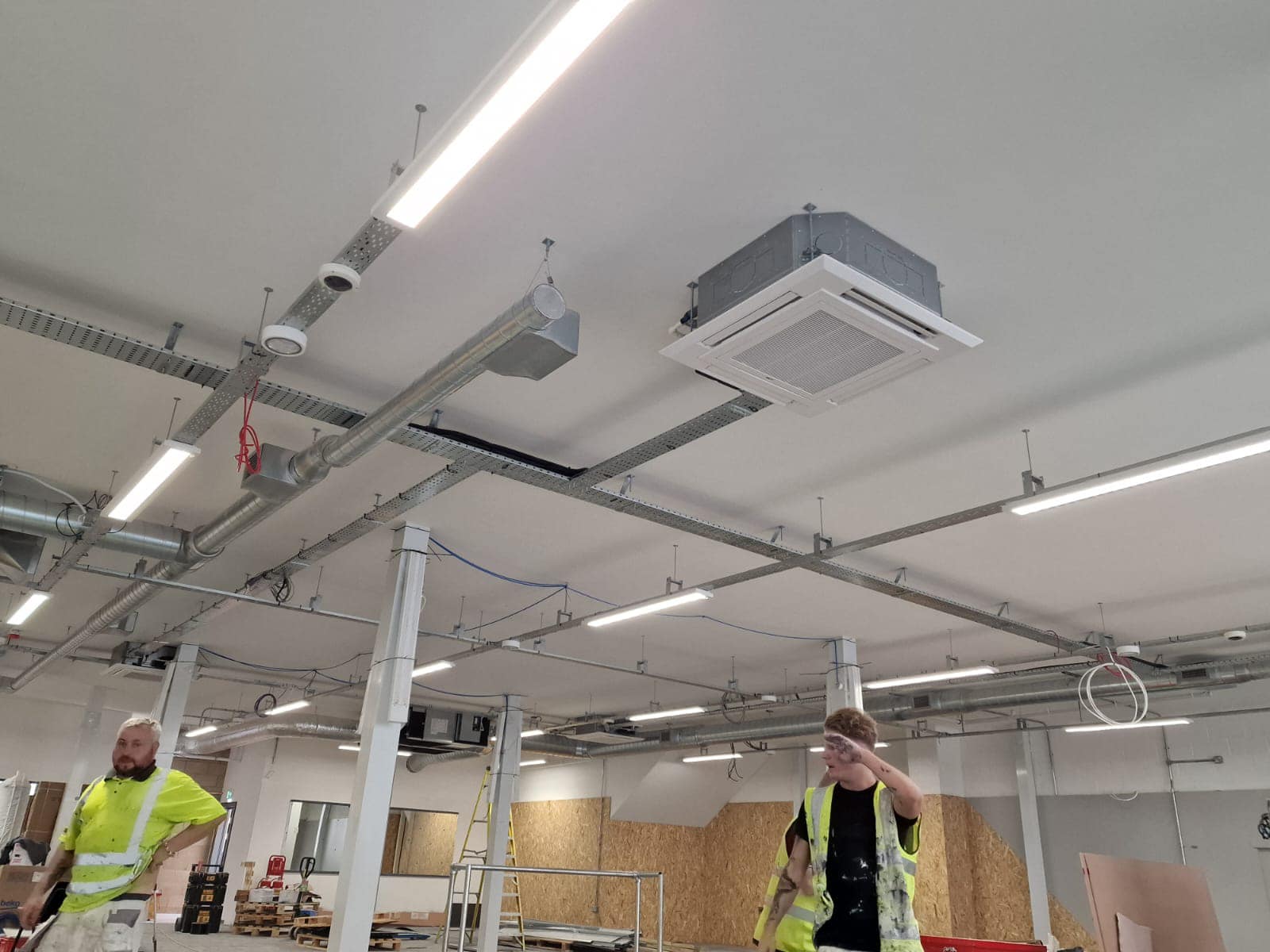 Air conditioning engineers installing commercial air conditioning units in Kettering